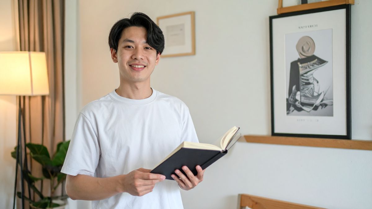 爽やかな男性が本を持っている